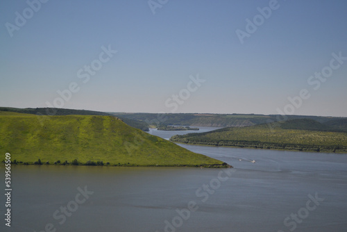 Ukraine. Bakota blue river green meadows ships float on water