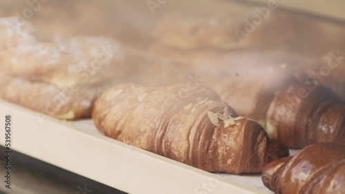Close ip footage of beautiful tasty fresh croissants on shop. photo