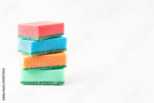 Foam sponges for dishes lined up in a stack on a white background, space for text.