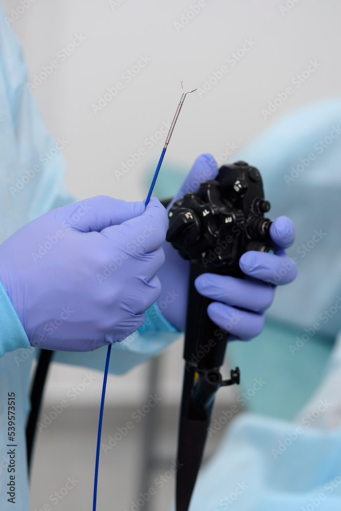 Instruments for gastroscopy closeup. The doctor holds in his hands a