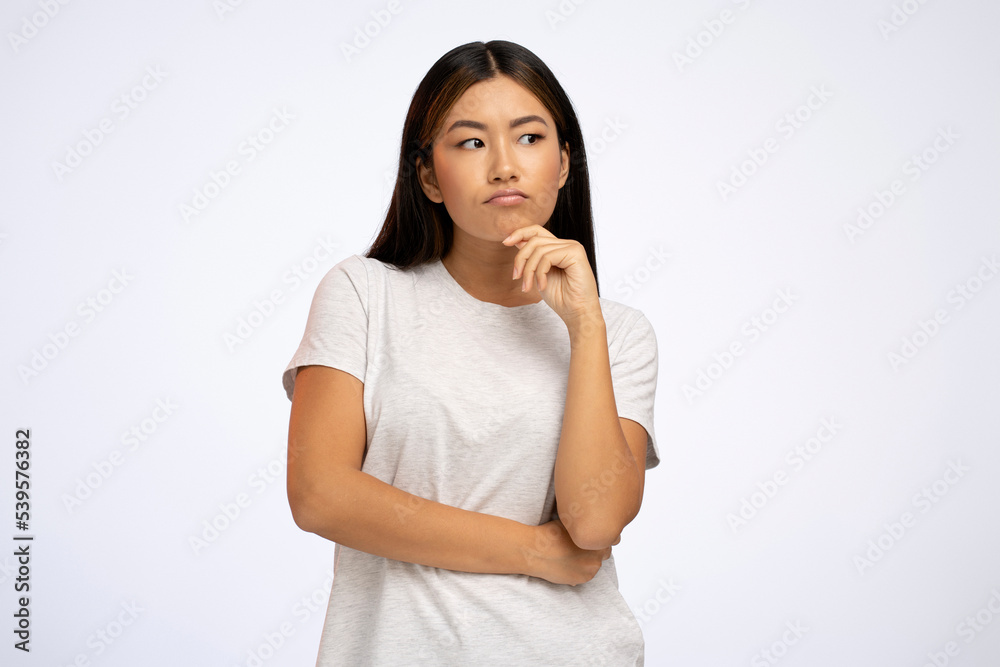 Portrait of woman standing with thoughtful serious smart expression, pondering answer Portrait of woman standing with thoughtful serious smart expression, pondering answer
