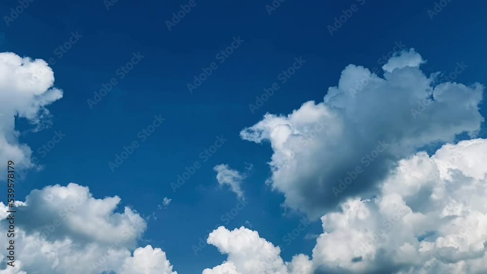 Timelapse of large clouds moving in the blue sky