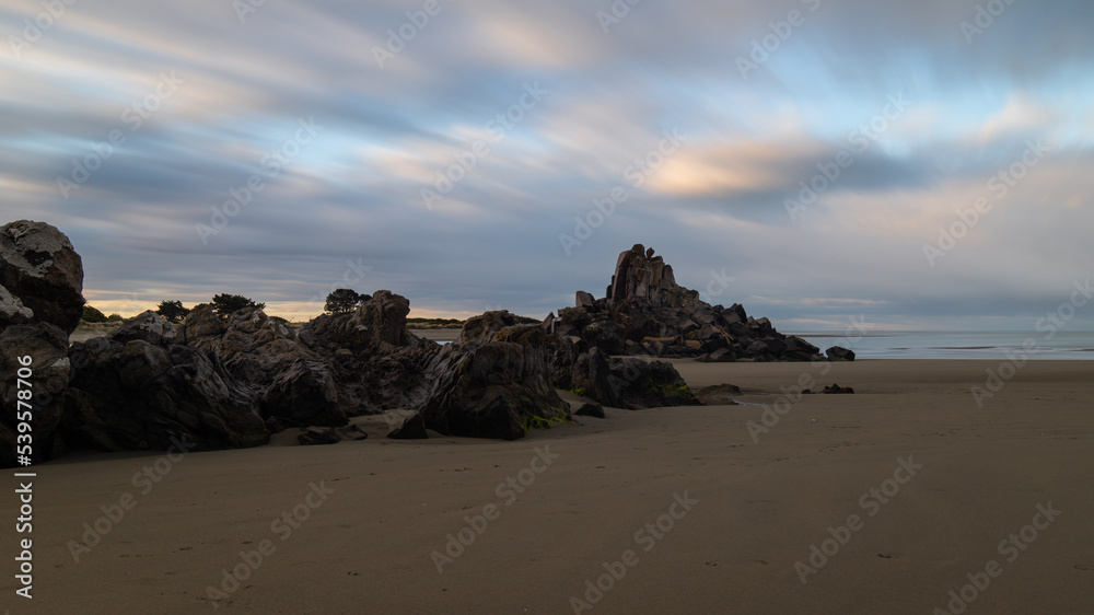 Beautiful rock formation of Shag Rock on beach coastline, Christchurch, New Zealand.