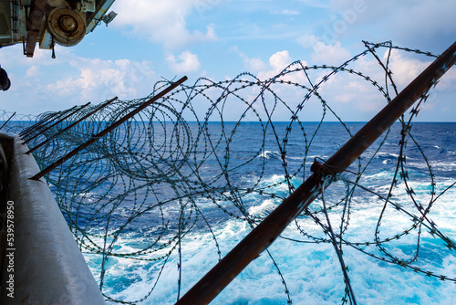 Ship's stern fortified with razor wire. Anti piracy protection is mounted before entering (HRA) Piracy High Risk Areas to prevent illegal boarding.