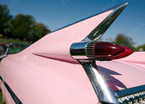 Tail fin on a pink 1950s classic car