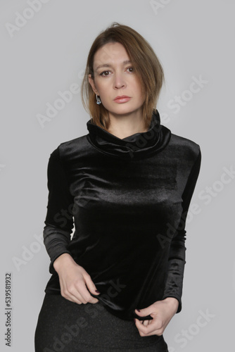 Serie of studio photos of female model wearing plush black turtleneck, elegant yet cozy and warm clothng. photo