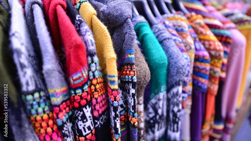 Made in Peru handicraft woolen, jackets, sweaters and vests made from alpaca with traditional design at market. © Grand Warszawski