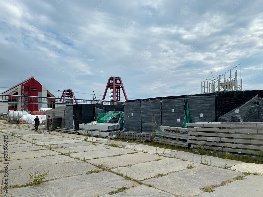 Boxes with equipment at the construction site of a factory in an open