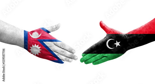 Handshake between Libya and Nepal flags painted on hands, isolated transparent image.