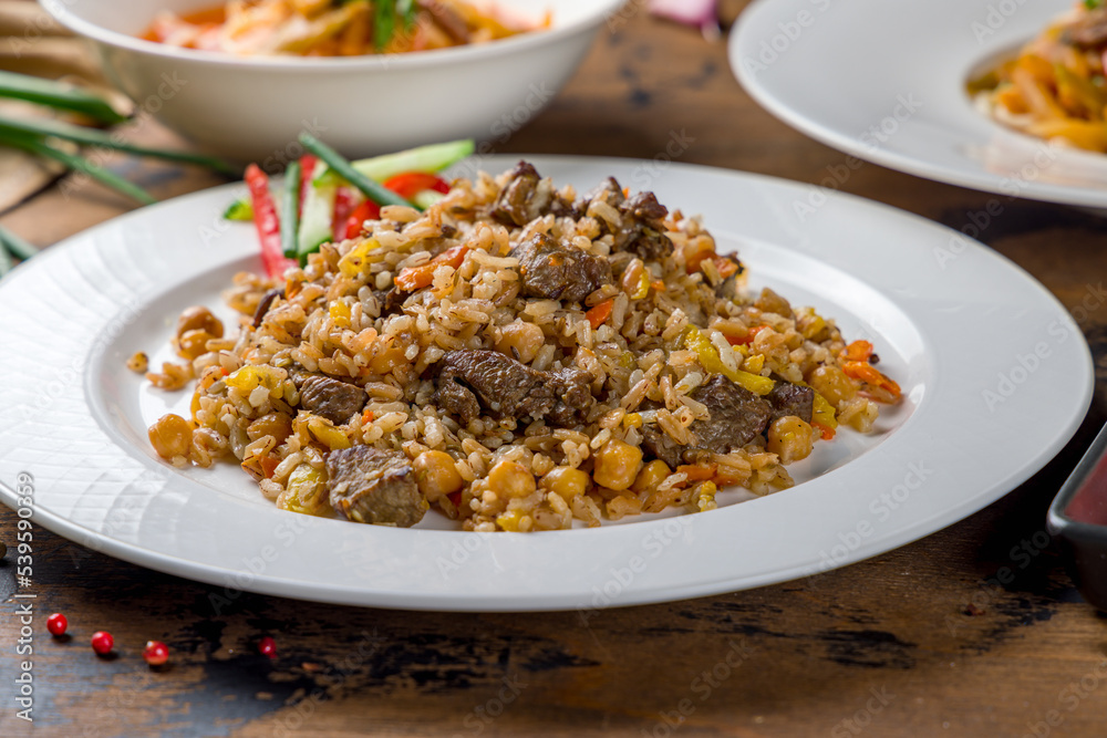 pilaf with beef on wooden table macro close up pilaf with beef on wooden table macro close up