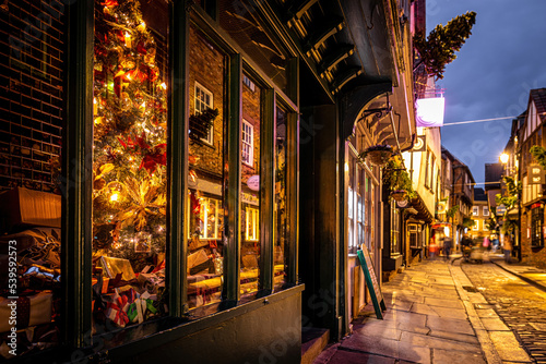 A Chirstmas night view of Shambles, a historic street in York featuring preserved medieval timber-framed buildings with jettied floors © Alexey Fedorenko