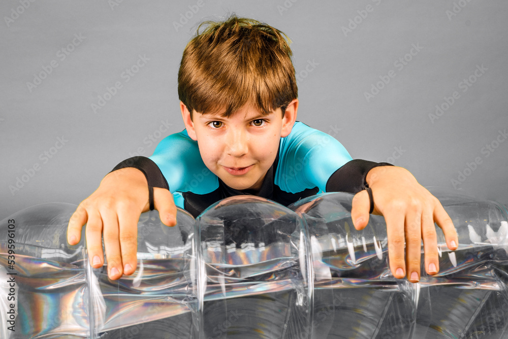 Boy Inflatable Raft Happy young boy swimmer grabbing and playing on an inflatable raft ...