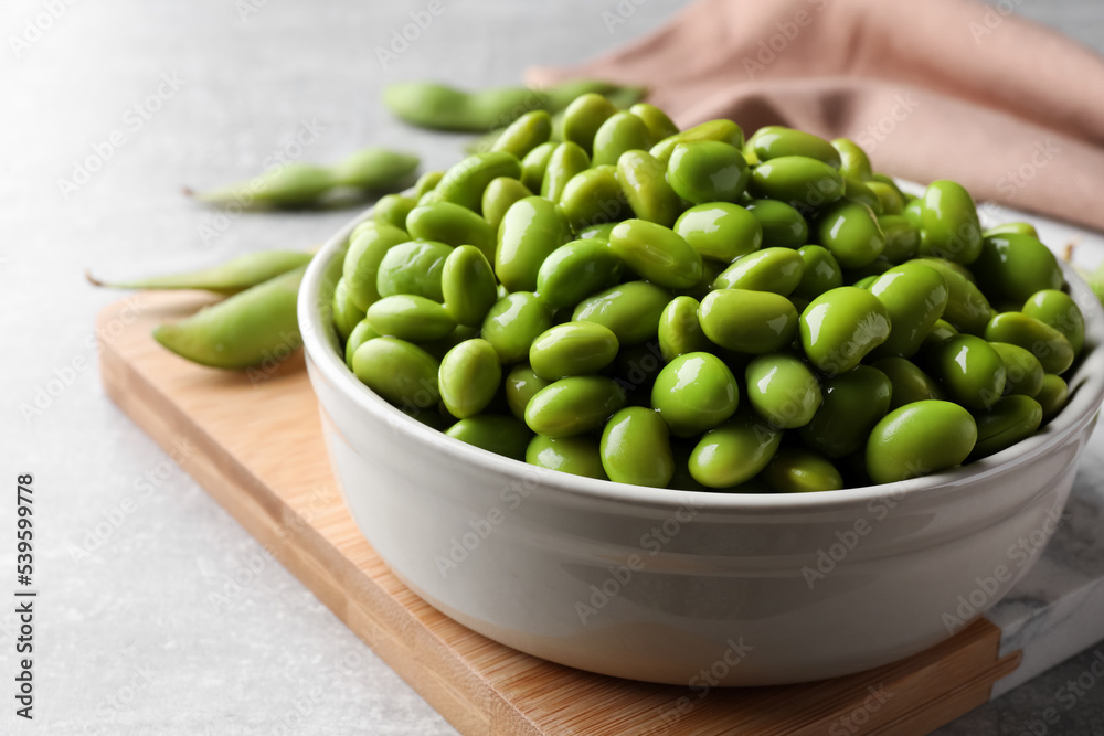 Bowl of delicious edamame beans on table, closeup Bowl of delicious edamame beans on table, closeup
