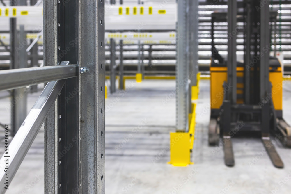 Modern large warehouse space interior, new and modern distribution storage with rows of empty high shelves and racks, concrete and steel, logistics complex inside Modern large warehouse space interior, new and modern distribution storage with rows of empty high shelves and racks, concrete and steel, logistics complex inside