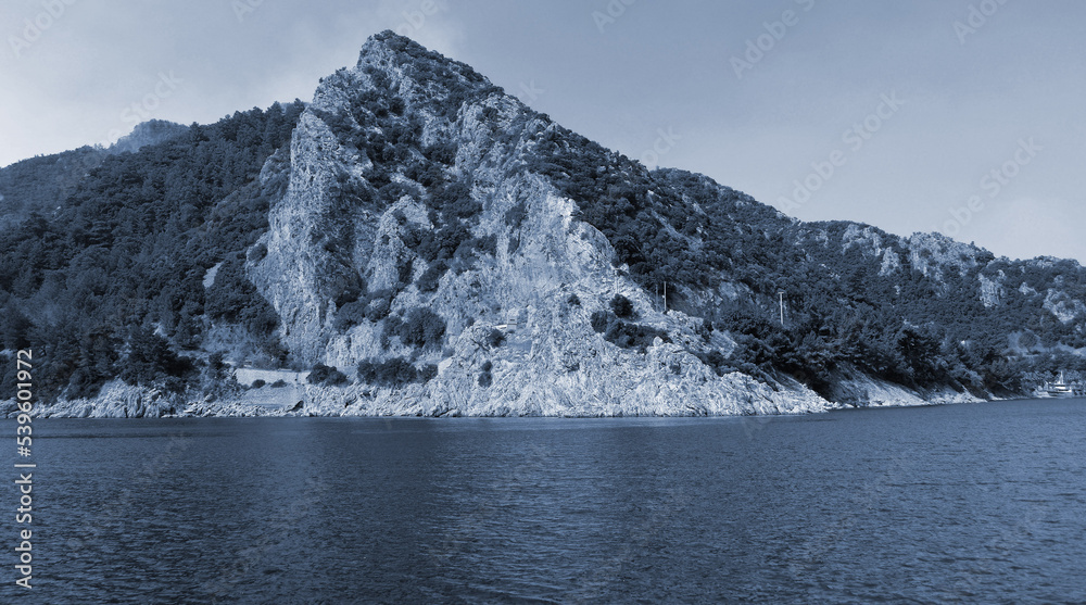 Picturesque view to Mediterranean sea with rocky cliff, bays and islands. Summer coast of Turkey in Marmaris region with transparent water and green mountains