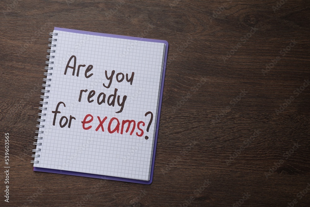Notebook with question Are You Ready For Exams? on wooden table, top view. Space for text Notebook with question Are You Ready For Exams? on wooden table, top view. Space for text