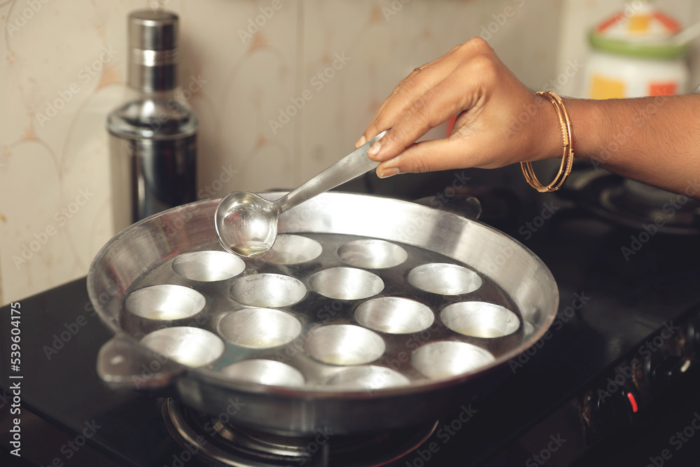 South Indian traditional food spicy Chettinadu kuzhi paniyaram is being prepared	
