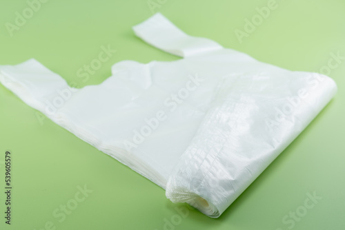 White plastic bag on green background
