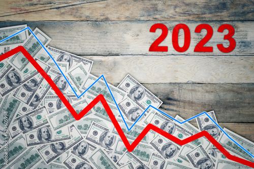 Declining arrow and money with 2023 number