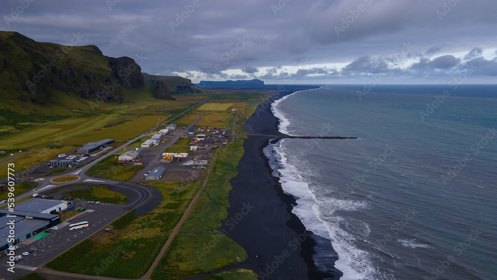Beautiful aerial view of the town of Vik near the black sand beach and the basalt rock formations in Iceland