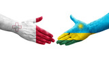 Handshake between Malta and Rwanda flags painted on hands, isolated transparent image.