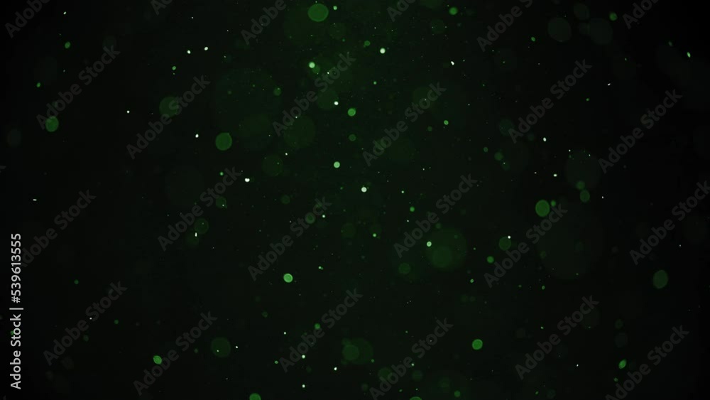 Green dust bokeh particles floating in the air. Slow motion. Green dust bokeh particles floating in the air. Slow motion.