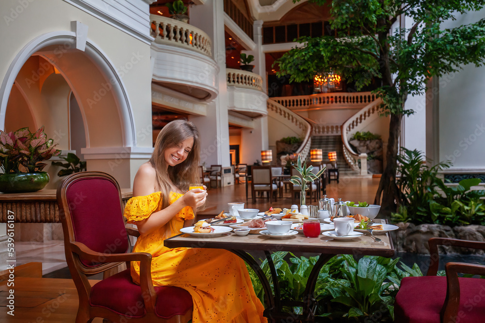 Woman drink fresh juice in luxury hotel restaurant on dinner or lunch Woman drink fresh juice in luxury hotel restaurant on dinner or lunch