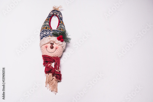 High quality photography. Christmas door decorations of a snowman. Christmas ornament for designs or template hanging on isolated white background.