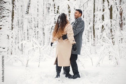 Portrait of a romantic couple dancing together in winter forest