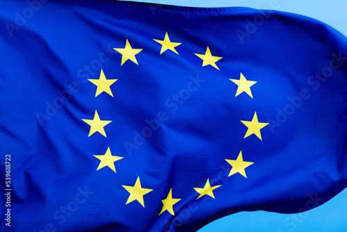 European Union Flag waving on blue background