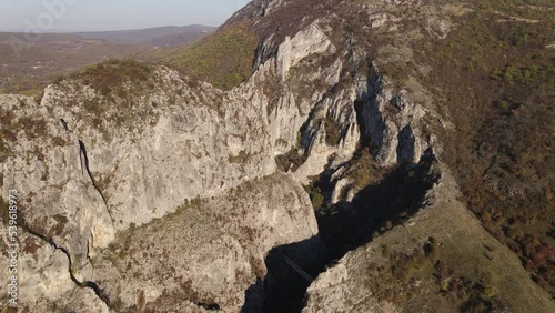 Stone rocks of the Nisevac near Svrljig in Serbia cliff and gorge rock on the mountain range in sunny day Aerial drone video over the hill photo