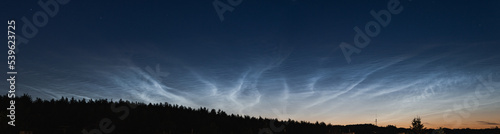 Noctilucent clouds, night shining clouds, are tenuous cloud-like phenomena in upper atmosphere of Earth, visible in northern hemisphere, most often in June July / summer nights. wide panoramic shot