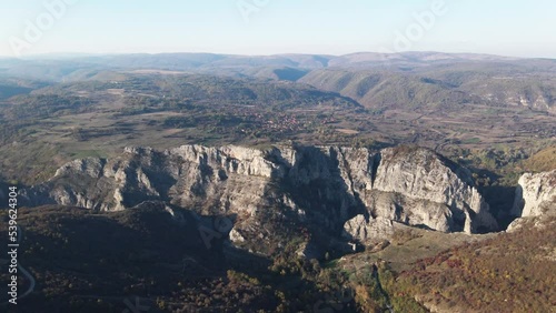 Stone rocks of the Nisevac near Svrljig in Serbia cliff and gorge rock on the mountain range in sunny day Aerial drone video over the hill photo