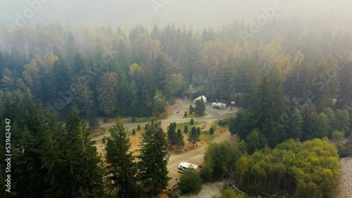 Aerial view of the camground in the forest on a foggy morning photo