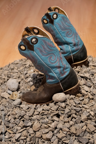 trival and traditional blue leather boots from mexico, on stones, mexico, photo