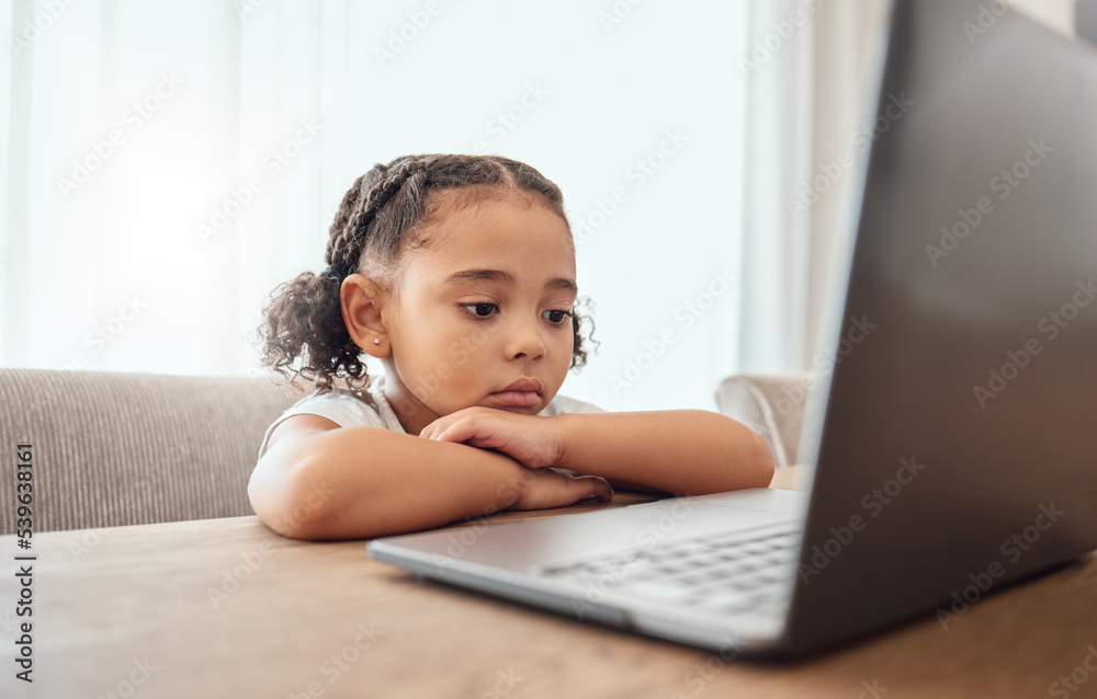 Children, laptop and education with a girl learning from home online for growth or development. Computer, internet and study with a female child distance learning at a dining room table in the house