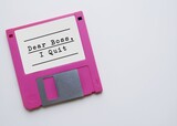 Vintage floppy disk with typed text DEAR BOSS I QUIT, concept of employess making decision to quit their job, escape 9-5 rat race, resign and build their own business