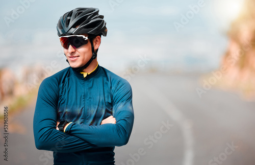 Cycling, cyclist or sports man, arms crossed and ready to cycle, ride or exercise on road. Health, wellness and happy male athlete from Canada preparing for workout, fitness or training outdoors. © Beaunitta Van Wyk/peopleimages.com