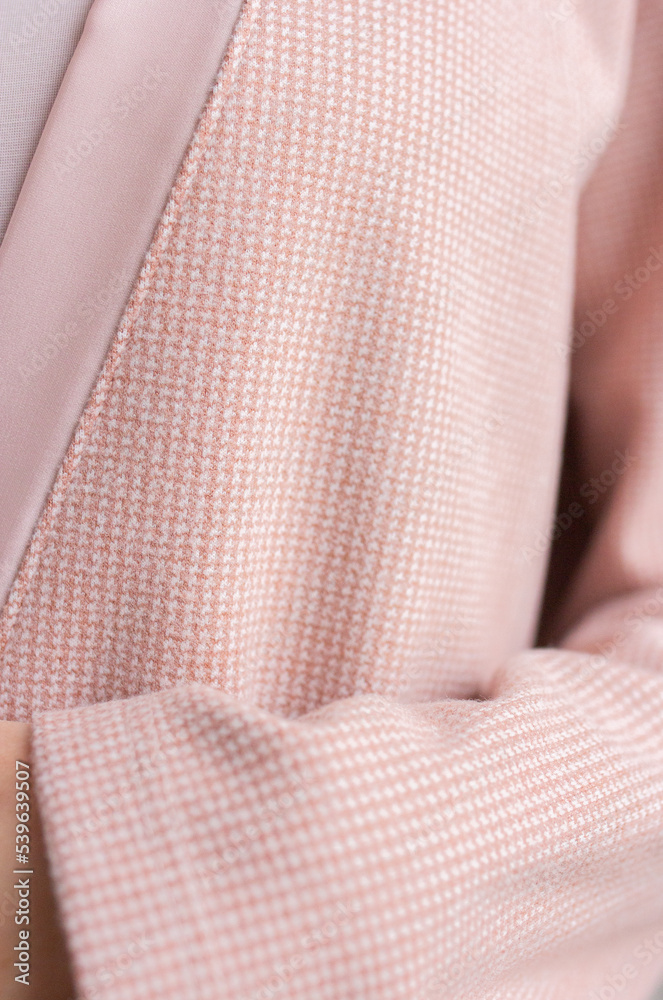 Pink cardigan textile close up with woman hand Pink cardigan textile close up with woman hand