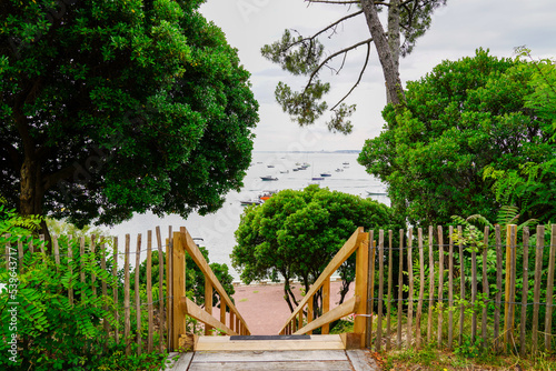 Coast access beach sea pathway stairs after pine forest to ocean atlantic coast at Lacanau in France photo