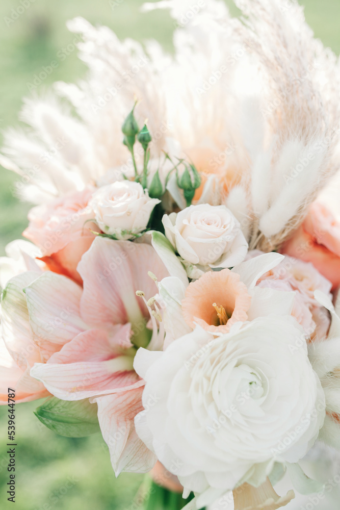Wedding bouquet of soft pink and white flowers close-up.