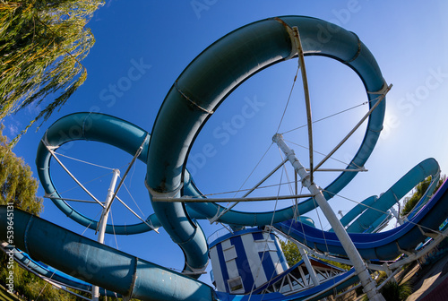 Tablou pe pânză Water slide in aquapark against blue sky