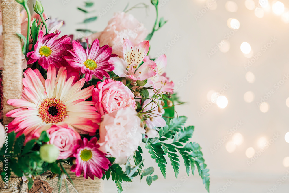 Fototapeta premium Beautiful pink flowers composition in the box close-up view. Festive decoration and background