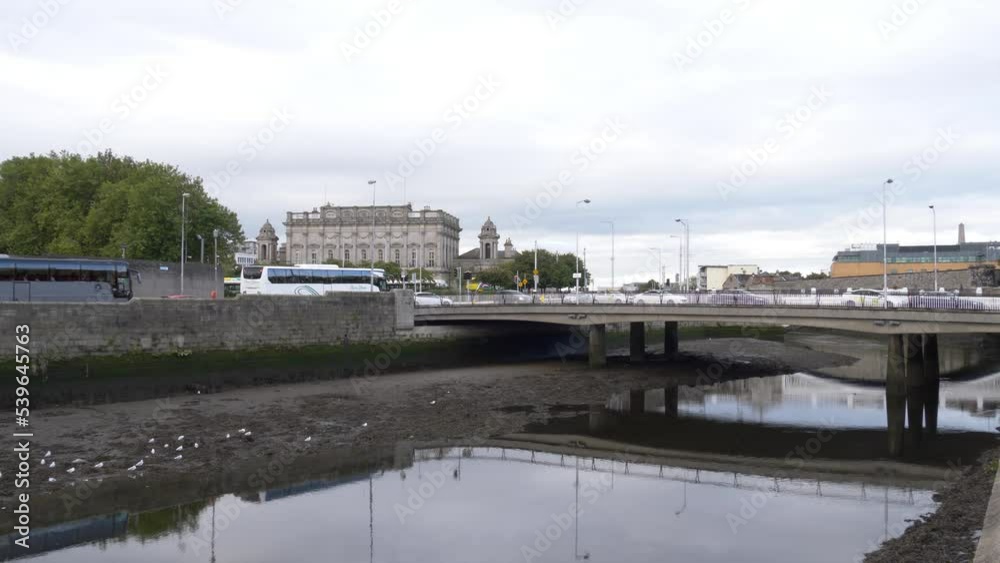 Cars Driving Across The Frank Sherwin Bridge Over River Liffey With Heuston Train Station In The Background In Dublin, Ireland. - wide Cars Driving Across The Frank Sherwin Bridge Over River Liffey With Heuston Train Station In The Background In Dublin, Ireland. - wide