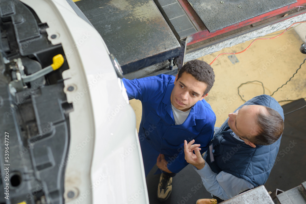 two mechanic repairing a car two mechanic repairing a car