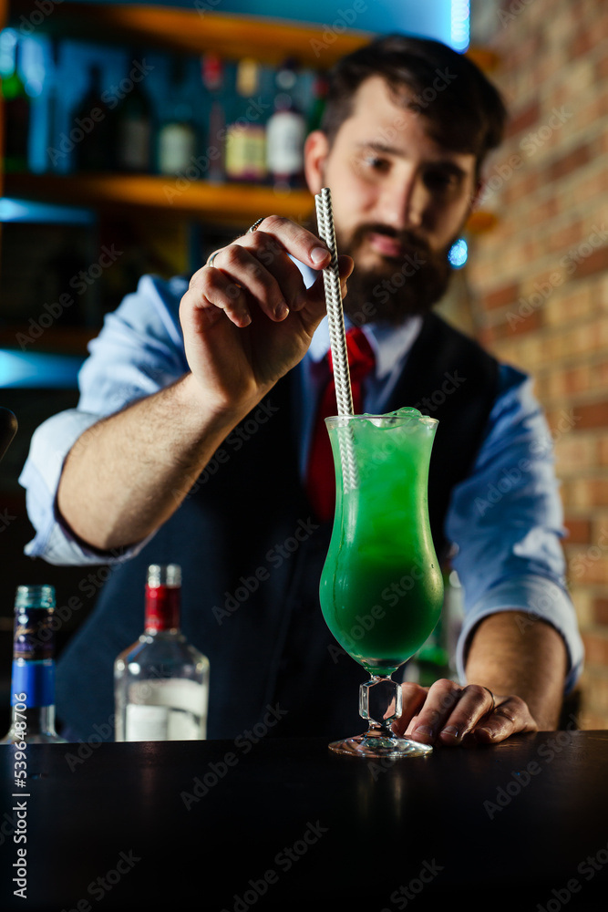 Close up of barman decorate blue lagoon cocktail