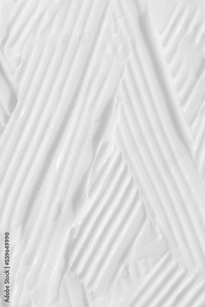 Obraz premium The texture of the white cream. Cosmetic background. Cosmetic product for body care. Wellness and beauty concept.