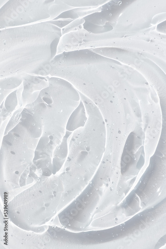 Transparent serum or gel with hyaluronic acid for the face. Textured background with oxygen bubbles. Wellness and beauty concept.