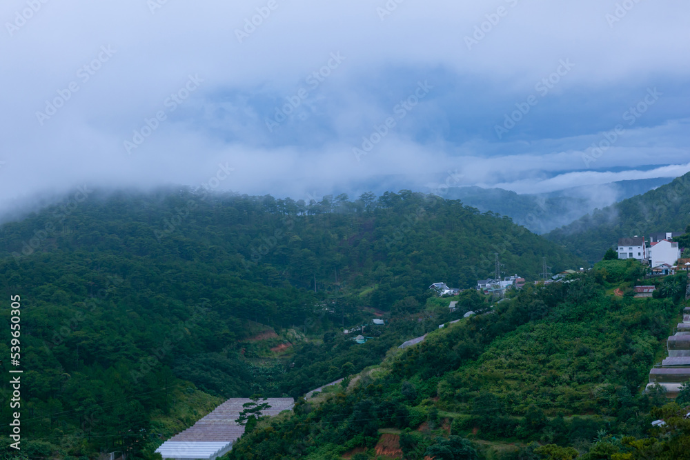 Fototapeta premium the layers of mountain with sunlight and clouds in Da Lat, Lam Dong, Viet Nam