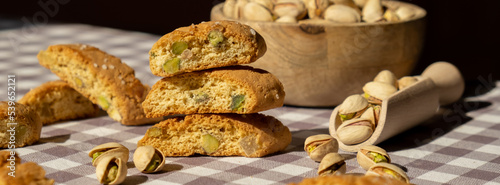 Biscotti Cantuccini Cookie Biscuits with pistachios and lemon peel Shortbread. Healthy eating food. Homemade fresh Italian cookies cantucci stacks and organic pistachios nuts. Vegan dieting vegetarian photo